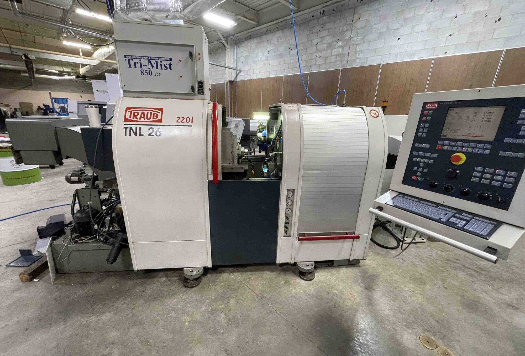 Traub TNL26 CNC Swiss Lathe, 2001- LNS Bar Feeder, Mist Collector, Conveyor, 34 Stations, Live Tools