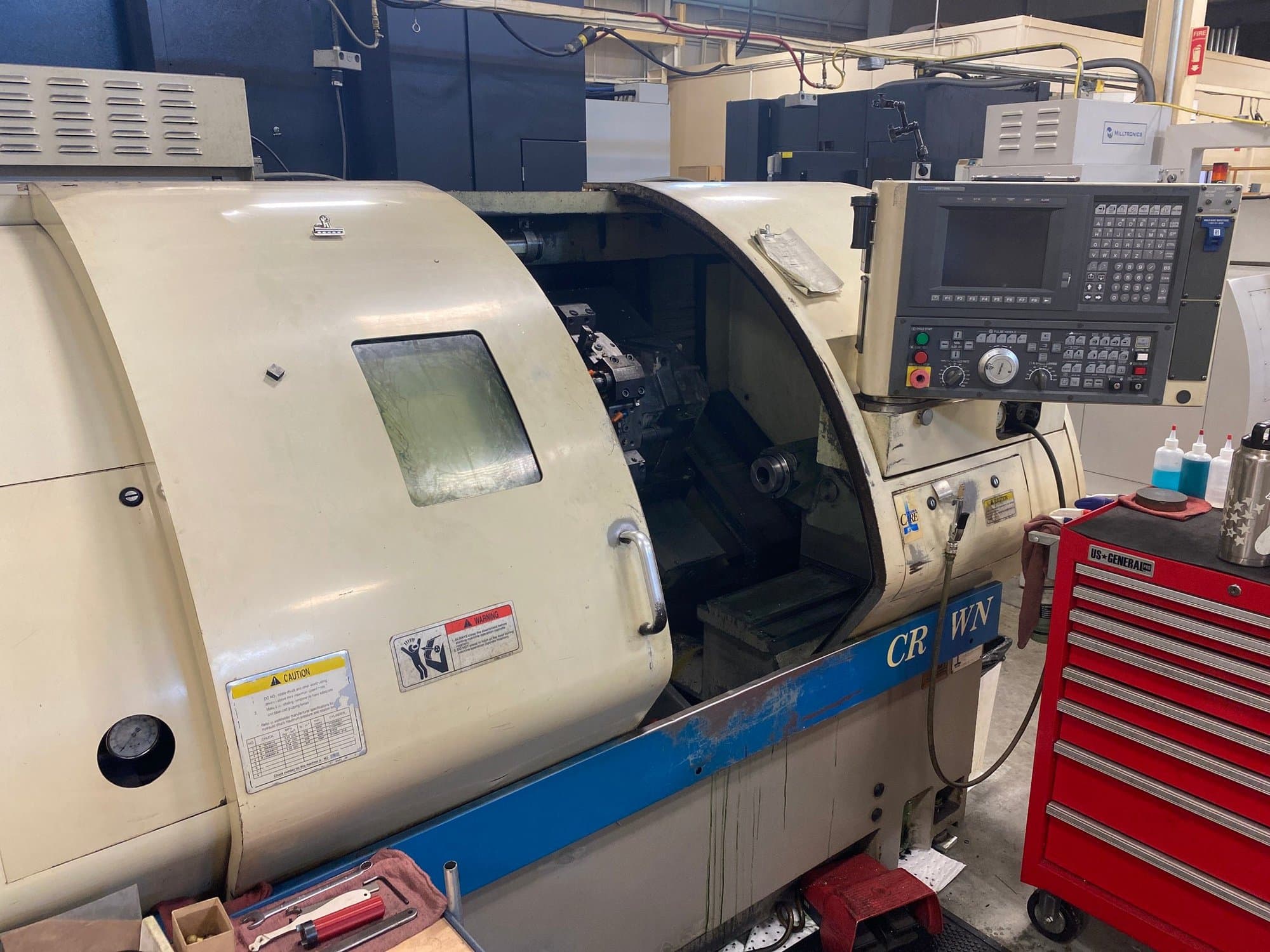 Okuma Crown 762E CNC Lathe, 1997 - w/OSP700L Control, 8" Chuck, Tool Holders