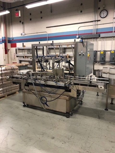 Liquid Packaging Solutions 4 Head Liquid Filling Line, In-feed and Out-feed Conveyor, and rotating collection table. 2017