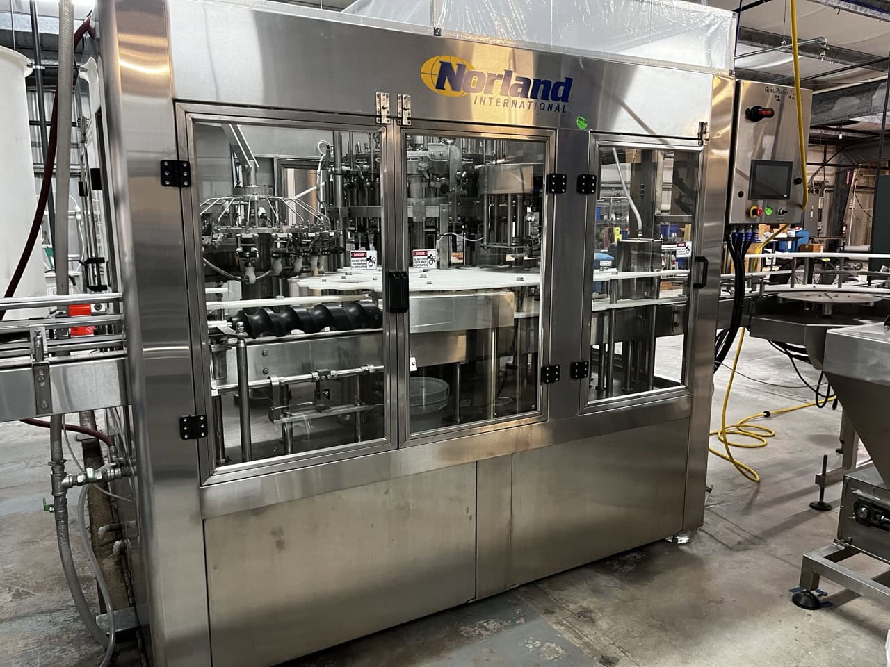 Norland International Complete line with (2) GlassPak66 Monoblock Systems (16oz and 25 Oz) for Glass or Aluminum with Fluid Solutions 3 Head ROPP Capper, 2020: - Image 6